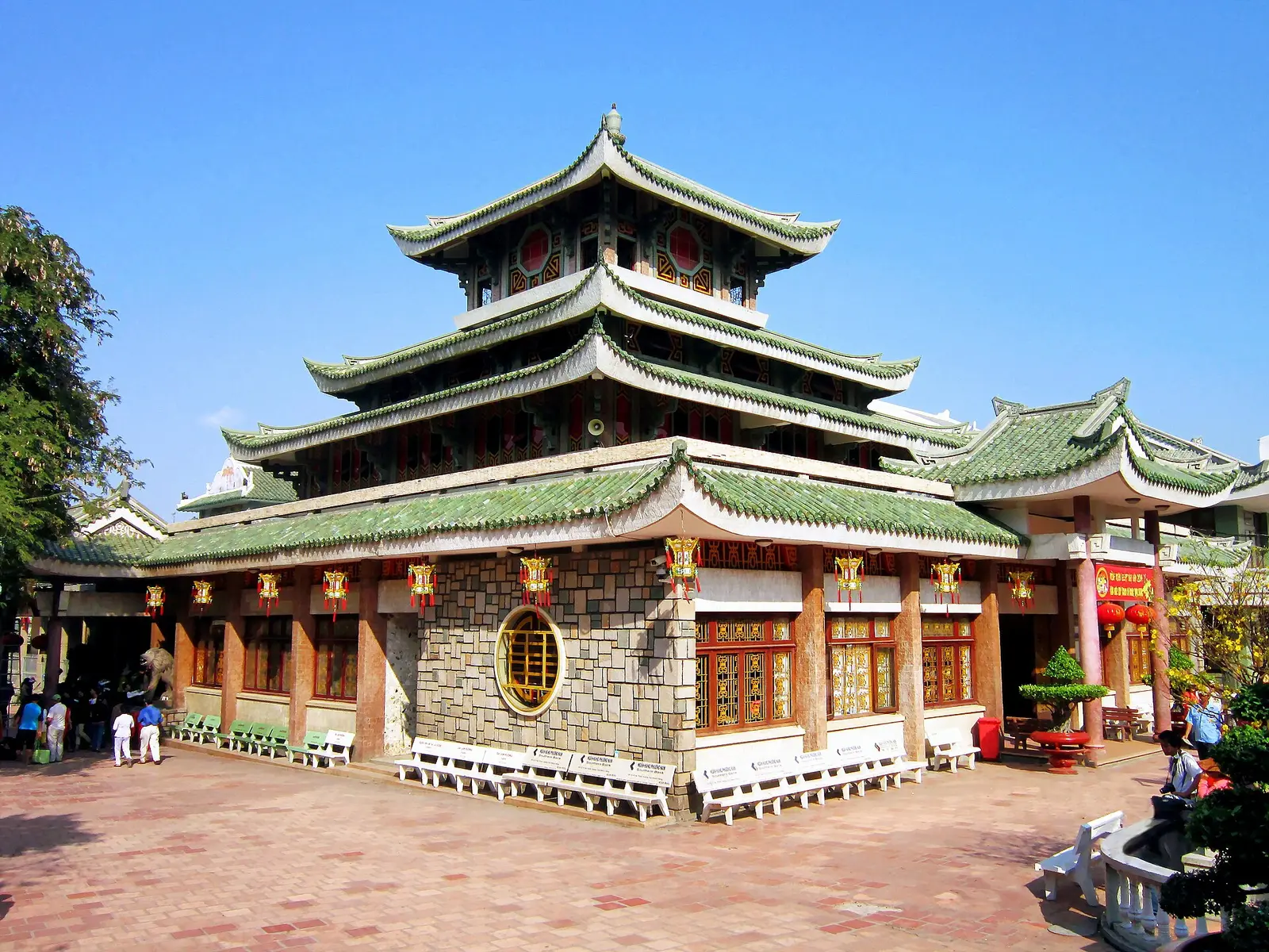De tempel Bà Chúa Xứ aan de voet van de Sam-berg, met groene daken in drie lagen en een tegelplein ervoor